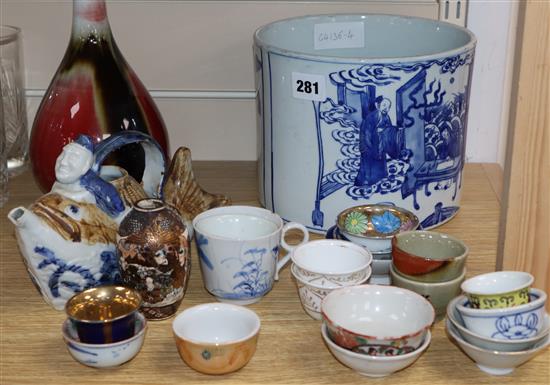 A quantity of Chinese and other porcelain including tea bowls, a bottle vase and a large blue and white brush pot